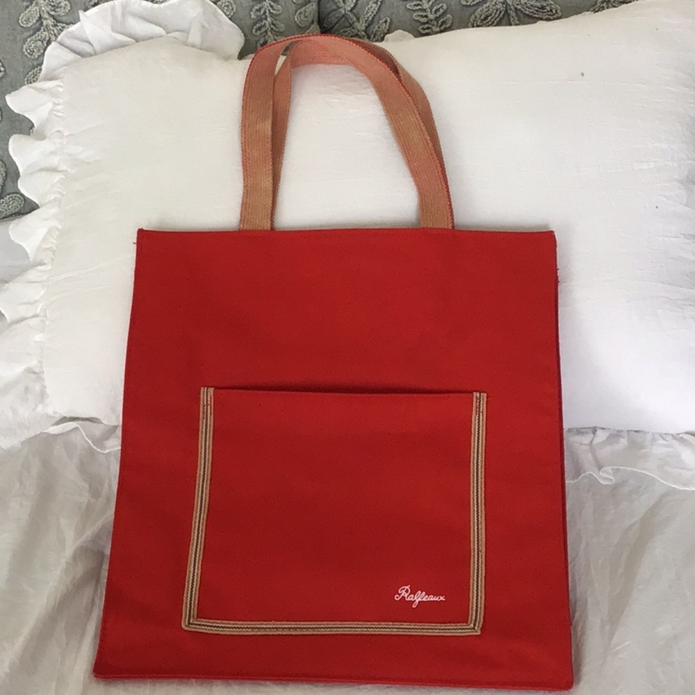 Red canvas tote bag with a front pocket